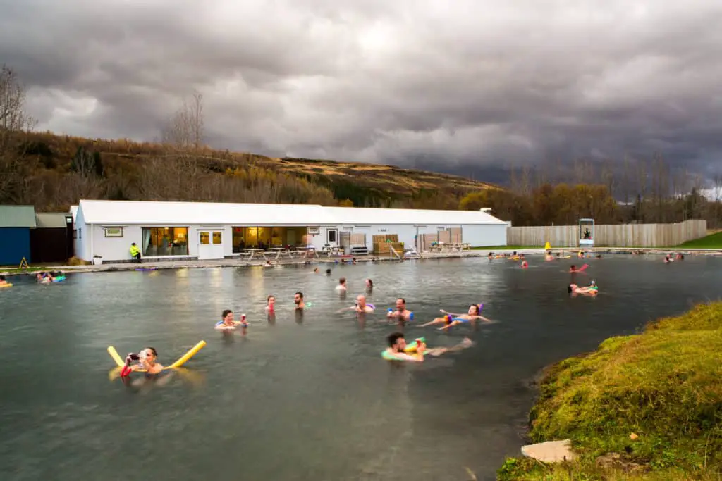 People swimming in Fludir's hot springs in Iceland