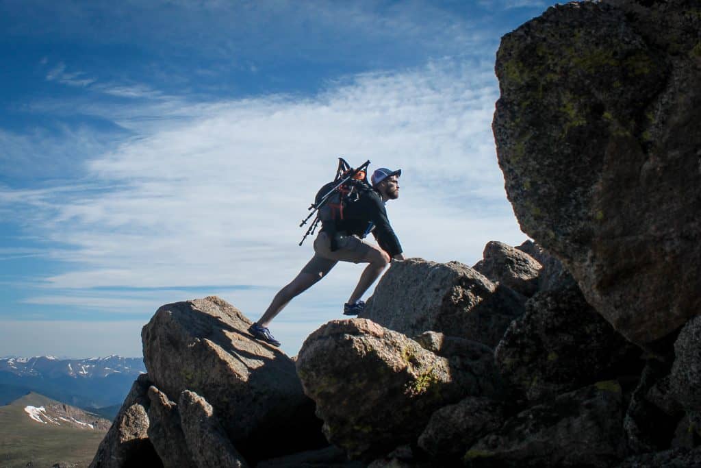 man hiking and climbing